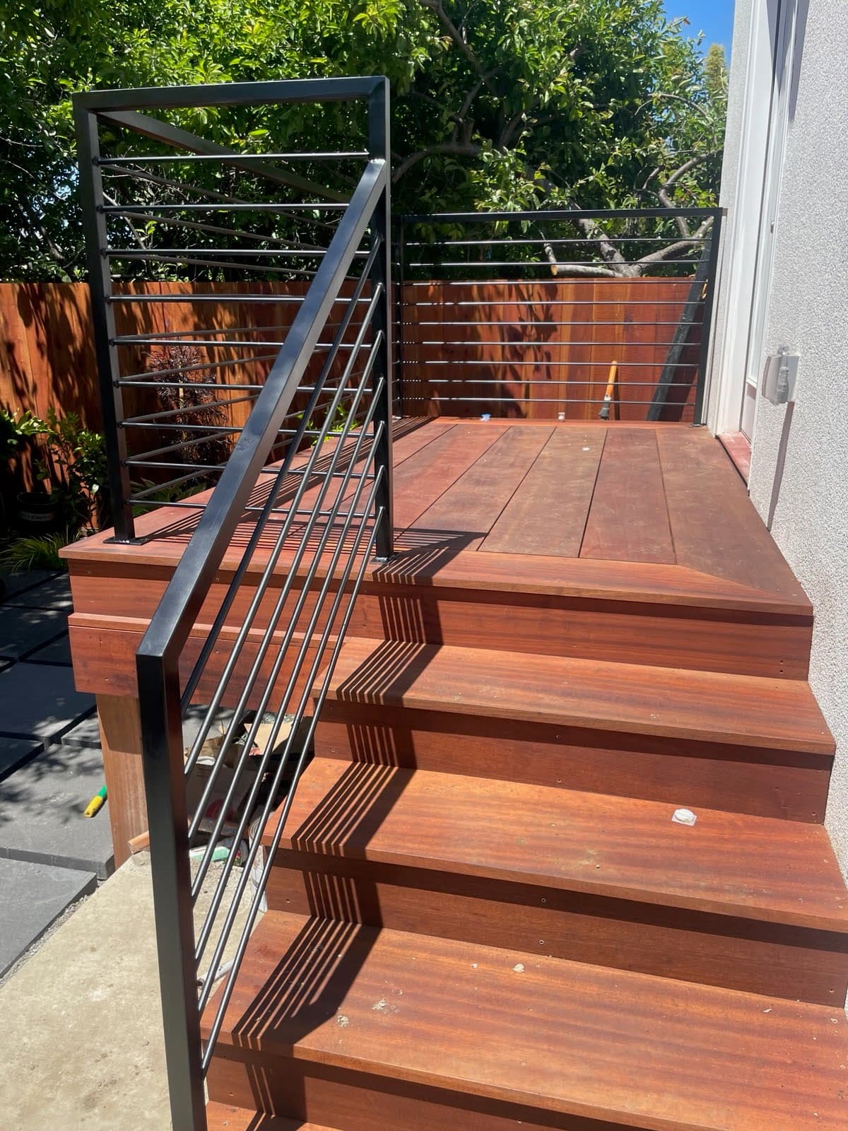 Hardwood deck stairs with black steel railing
